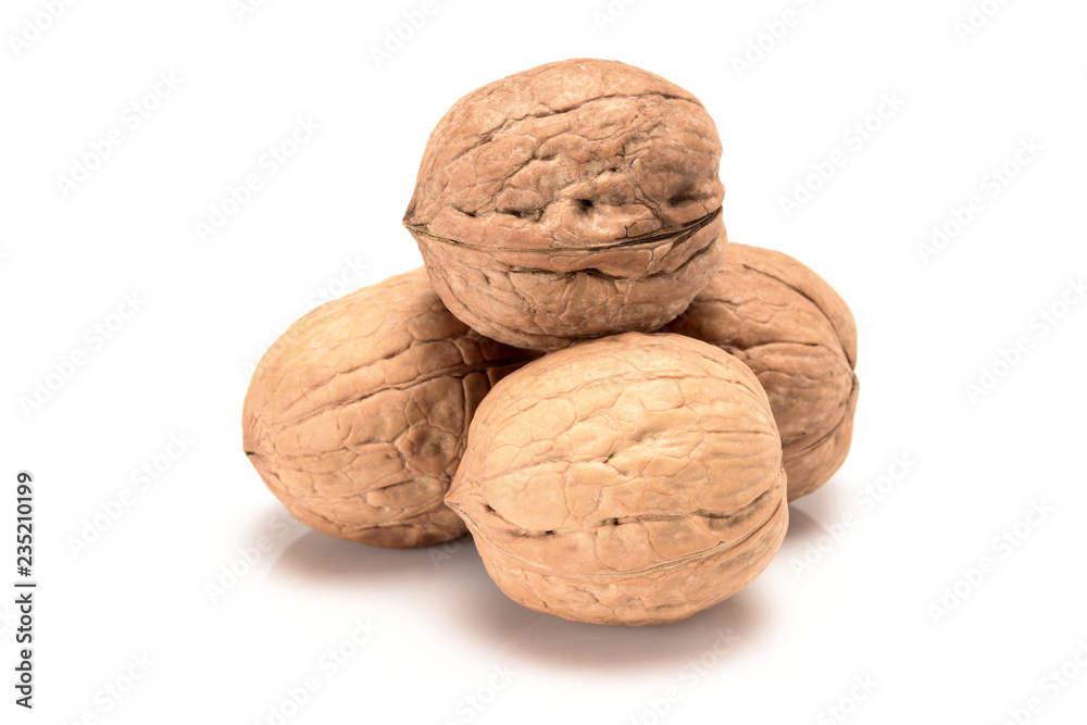 Four whole walnuts, close up macro, isolated on a white background. Four whole walnuts, close up macro, isolated on a white background.