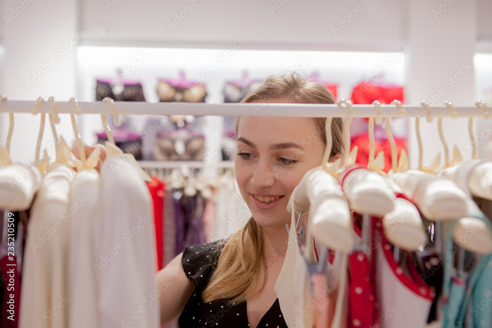 clothing, fashion, style and people concept - woman choosing clothes at home wardrobe