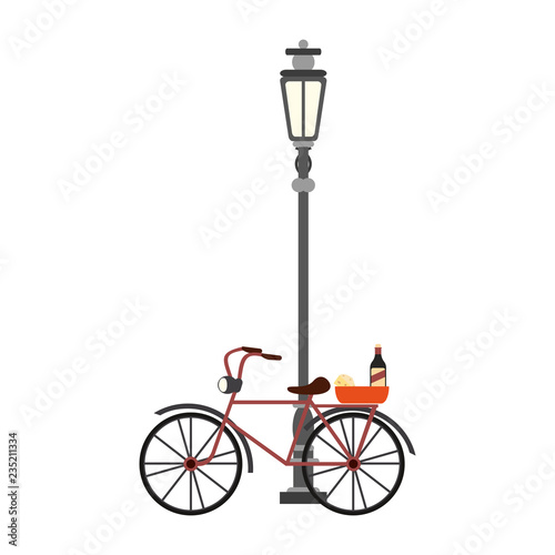 Vintage bike with wine and cheese on streetlight