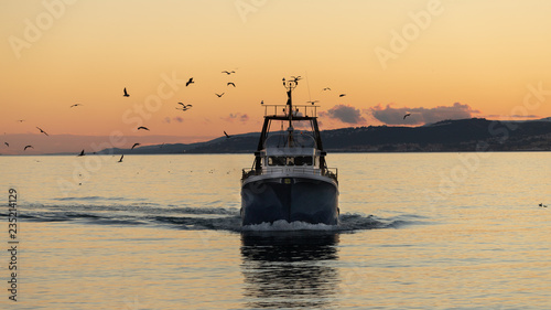 A fishing boat returning to port in Spain