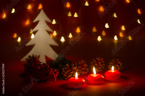 Christmas candles and ornaments over dark background with shaped bokeh lights photo