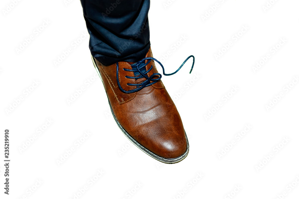 Leg in a brown boot with the untied lace. Isolated.