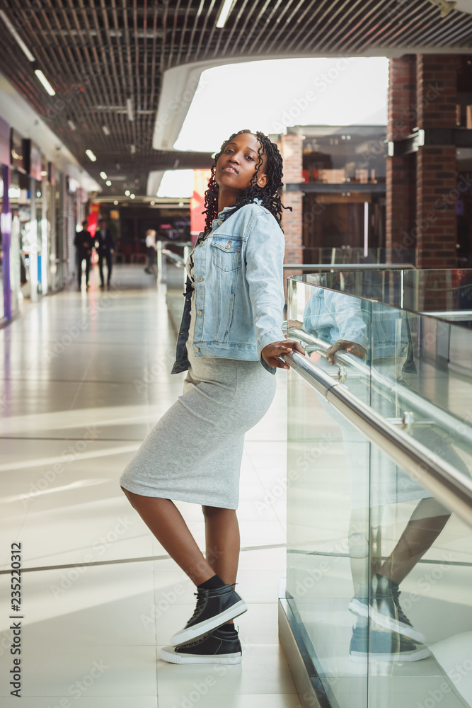 Young dark-skinned woman dressed in casual clothes in the mall
