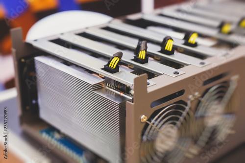 Close-up view of equipment for bitcoin cryptocurrency mining farm, electronic devices with fans, concept of mining technology photo