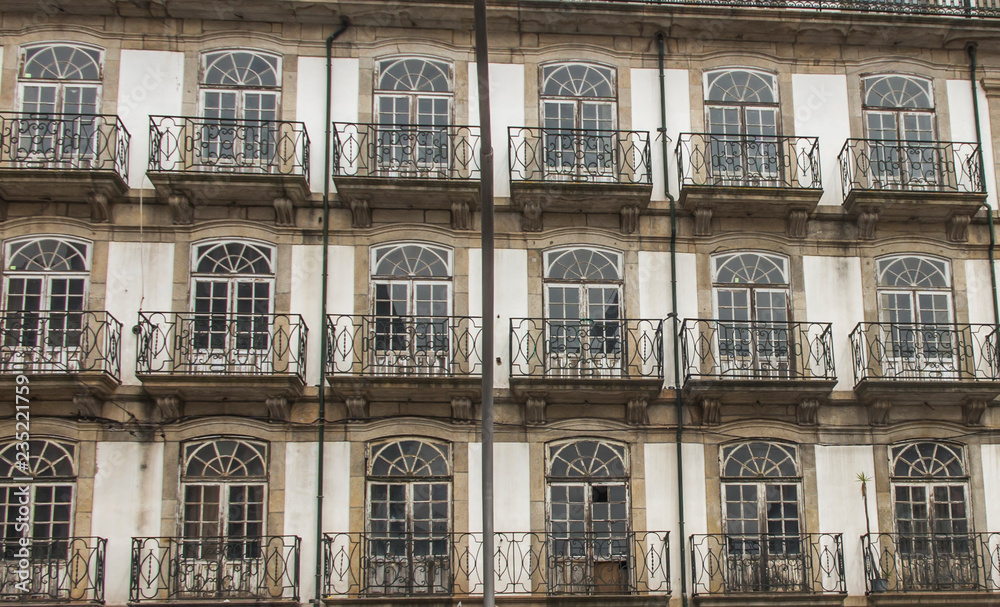 fragment of the wall of an old tenement house with windows in the city of Porto, Portugal fragment of the wall of an old tenement house with windows in the city of Porto, Portugal