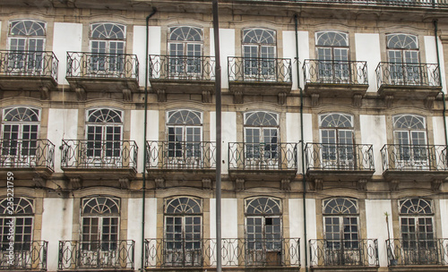 fragment of the wall of an old tenement house with windows in the city of Porto, Portugal