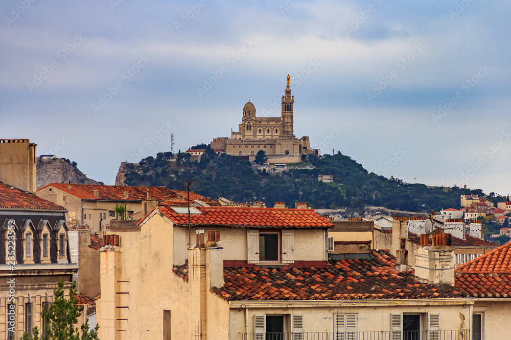 City rooftops and Notre-Dame de la Garde Catholic basilica on the hill, city's best-known symbol and site of a popular Assumption Day pilgrimage, the most visited site in Marseille, France