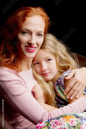 mother and little daughter gently embrace
