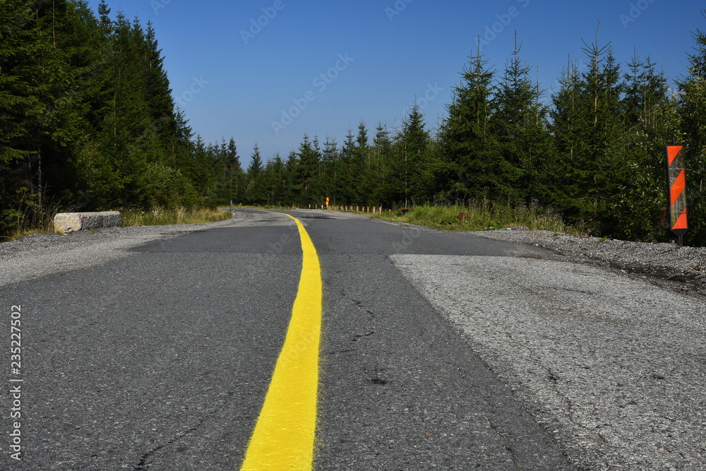 Yellow line in the middle of the mountain roadway.