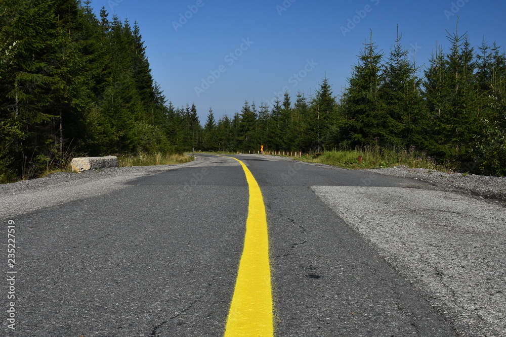Yellow painted line on the middle of the road.