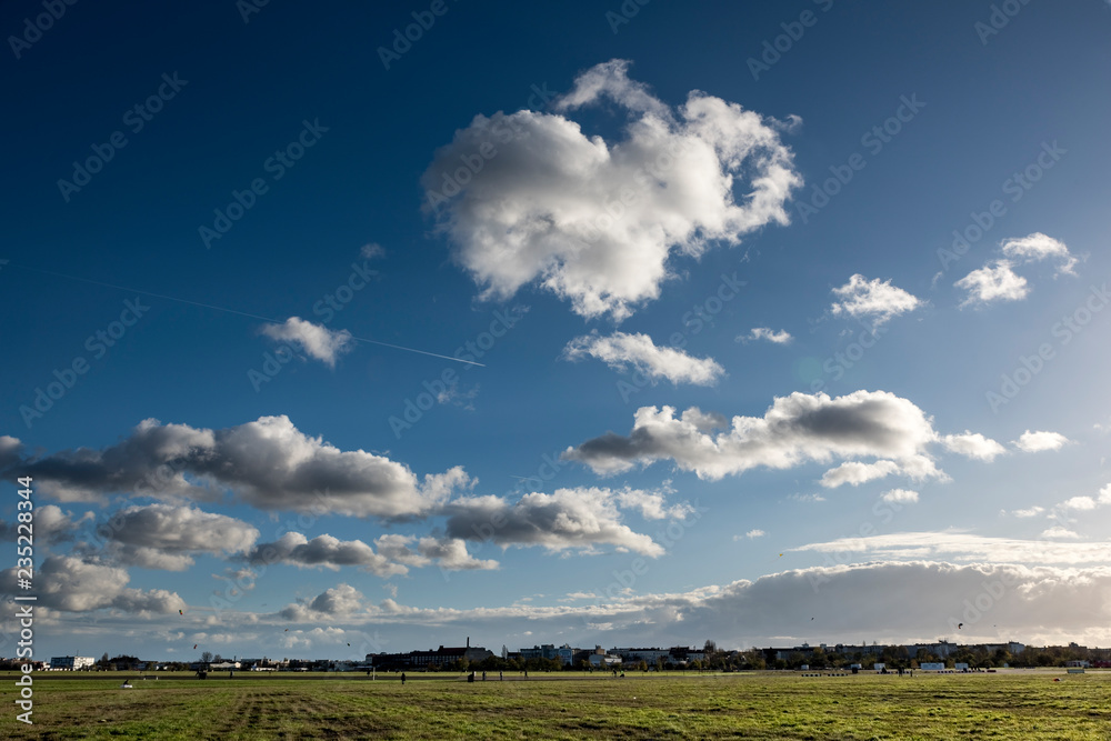 Cloudscape view on Tempelhof Fields in Berlin with unidentified visitors. Cloudscape view on Tempelhof Fields in Berlin with unidentified visitors.