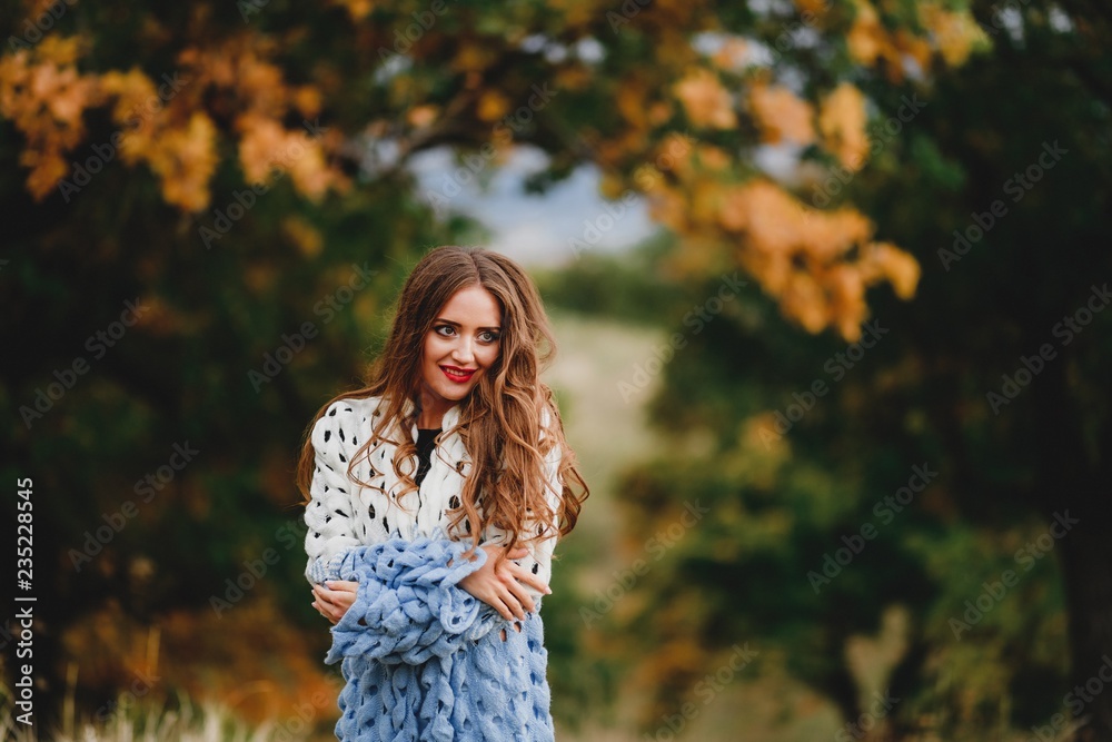 Beautiful girl in sweater in autumn forest. Beautiful girl in sweater in autumn forest.