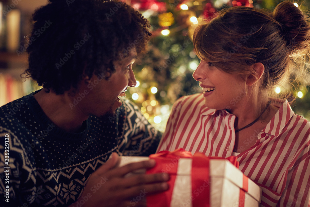 giving Christmas present to his girlfriend giving Christmas present to his girlfriend