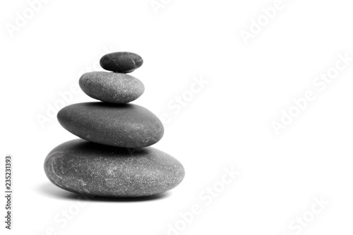 Stacked smooth grey stones. Sea pebble. Balancing pebbles isolated on white background