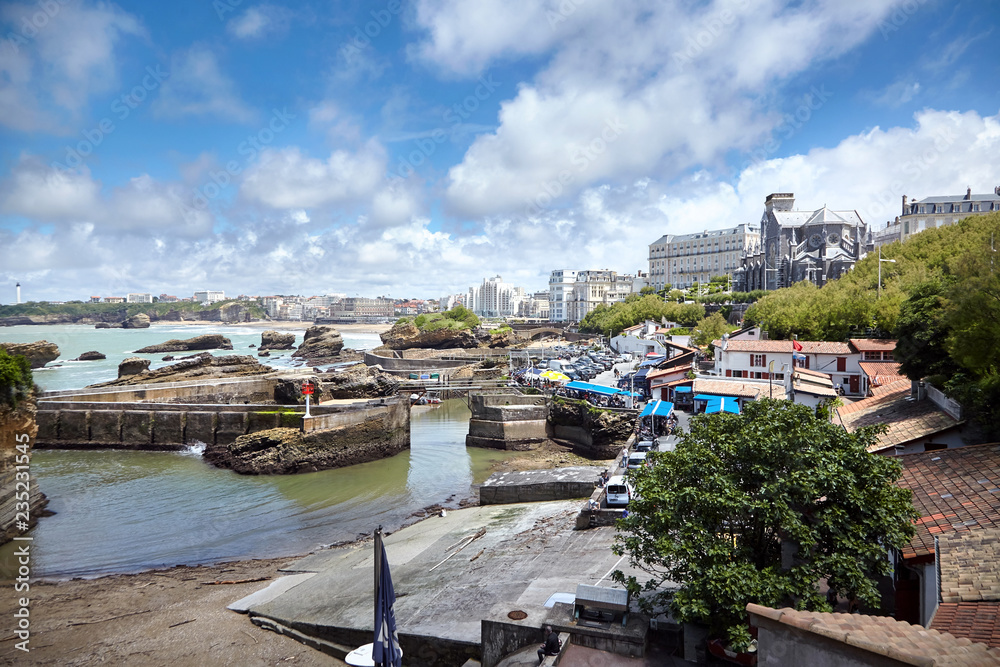 Cityscape of Biarritz, France: Old harbor and gothic church on the hill
