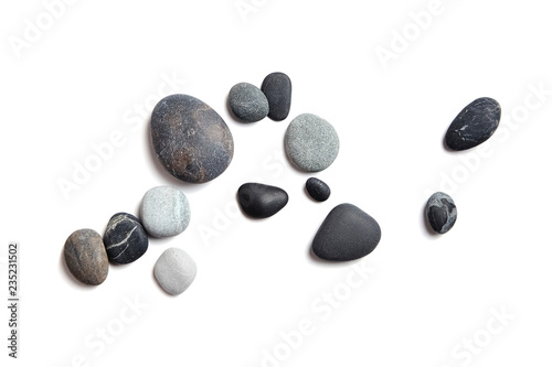 Scattered sea pebbles. Smooth gray and black stones isolated on white background. Top view