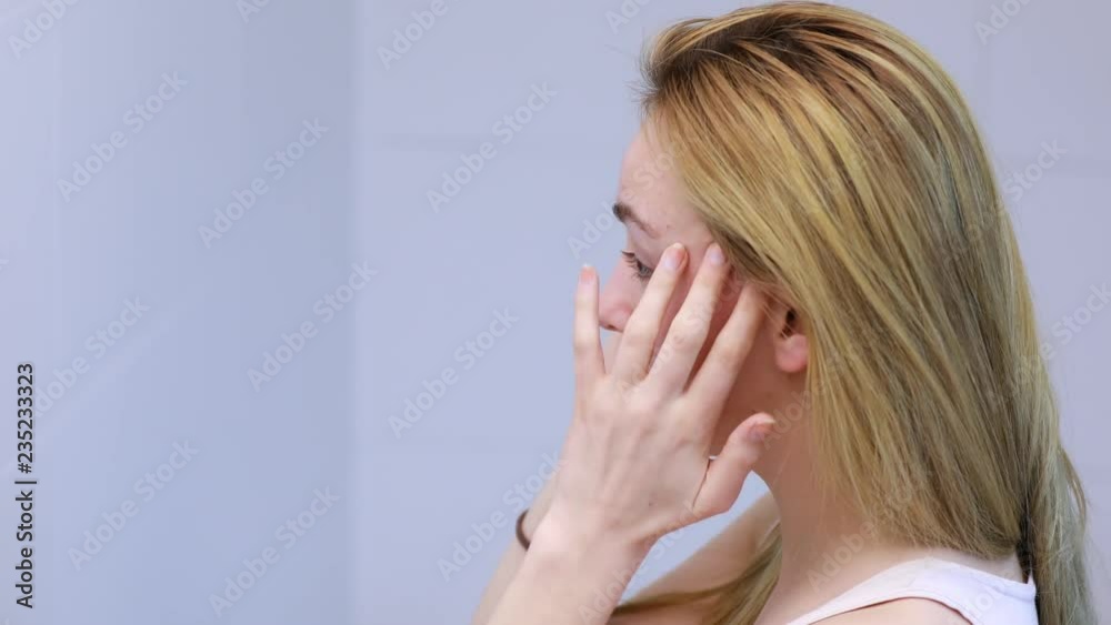 Young woman caring of her skin. Young woman caring of her skin.