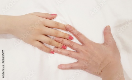 Conceptual iIsolated still image of two hands of different people signifying warmth  friendship and bond