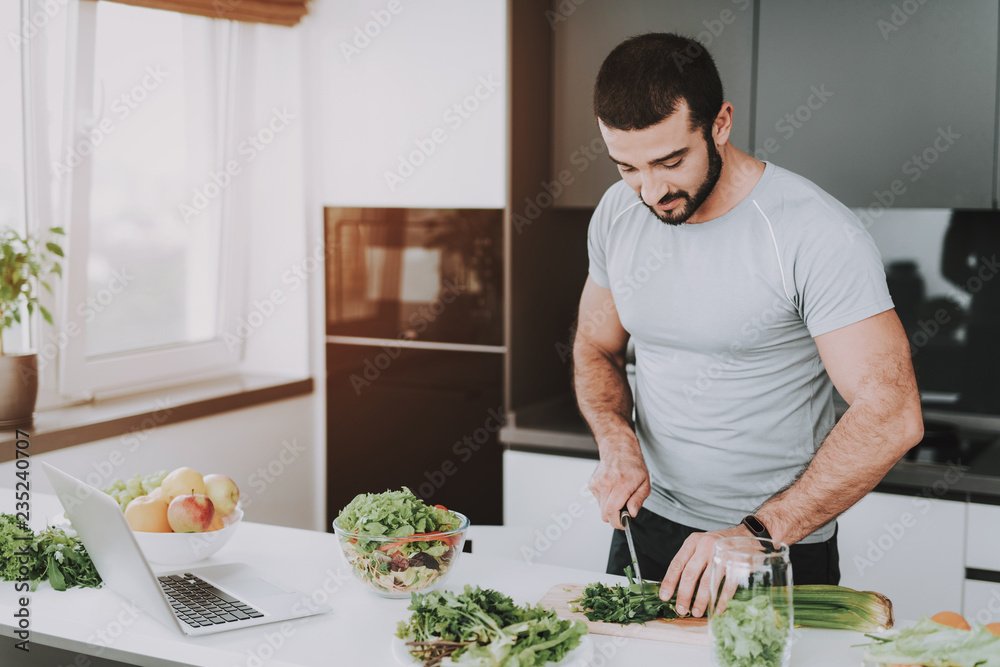 An Athletic Man Is Preparing Salad For Breakfast. An Athletic Man Is Preparing Salad For Breakfast.