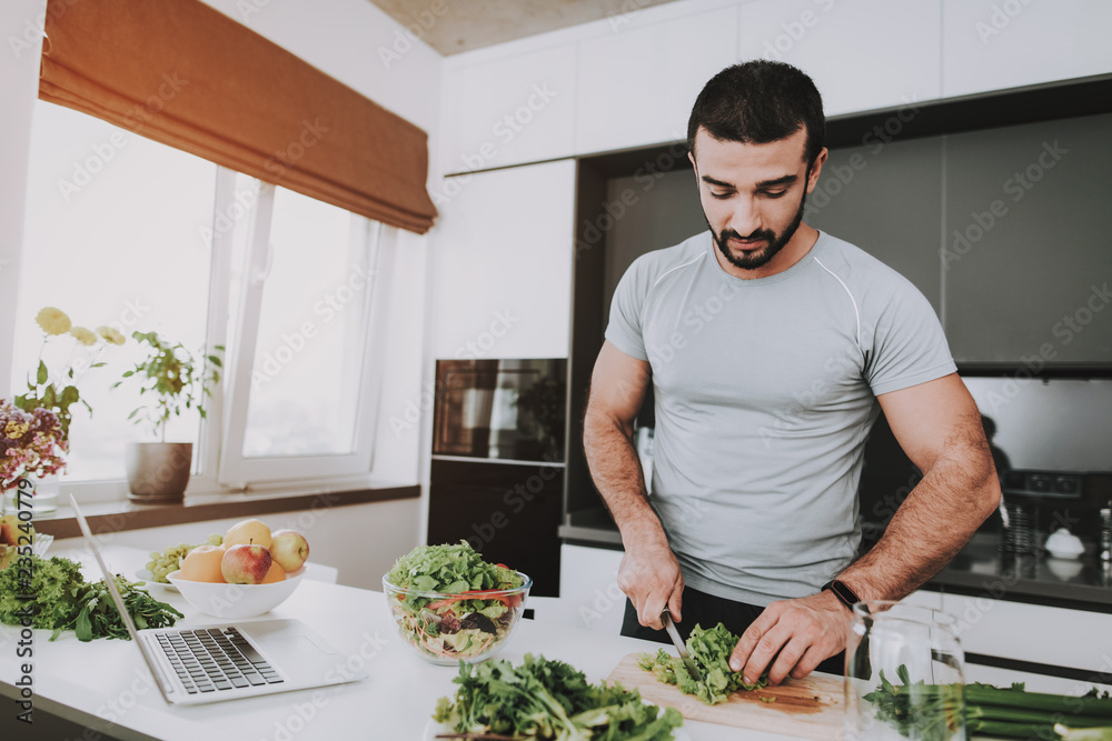 An Athletic Man Is Preparing Salad For Breakfast. An Athletic Man Is Preparing Salad For Breakfast.