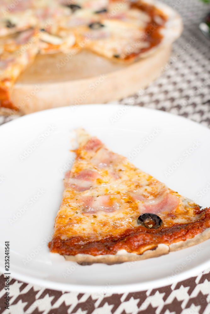 Italian pizza with ham olives and mushrooms