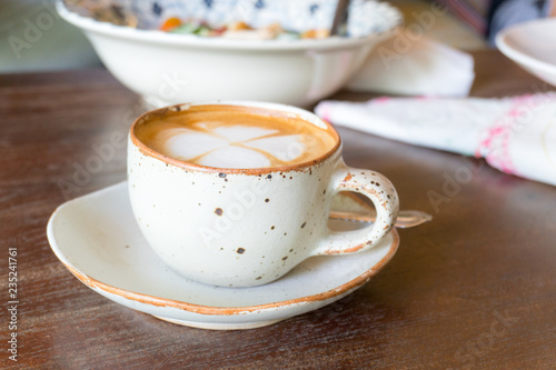 hot latte art coffee on white mug