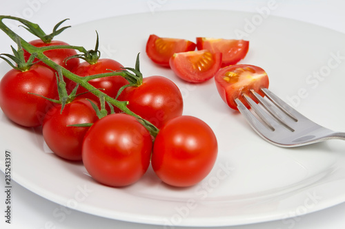 fresh tomatoes on white plate