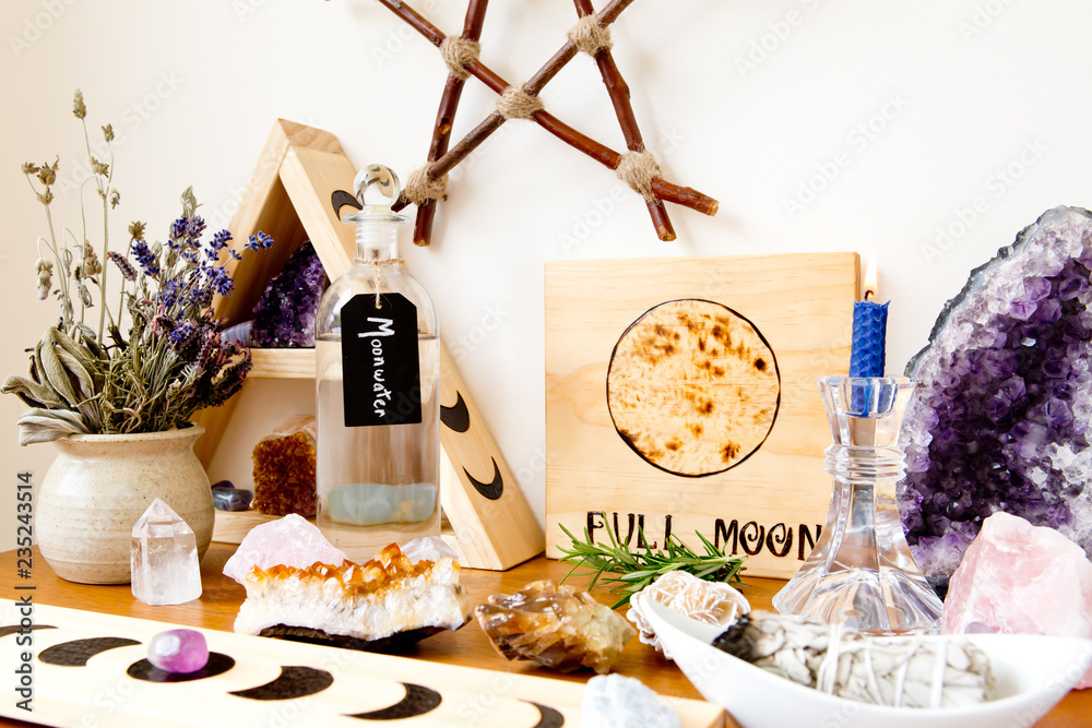 Fotka „Full Moon Altar setup for ritual, with herbs, crystals, candle,  moonwater and branch pentagram“ ze služby Stock | Adobe Stock