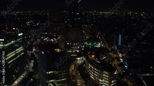 Aerial night panoramic view of Polanco district in Mexico City, drone asending and tilting down