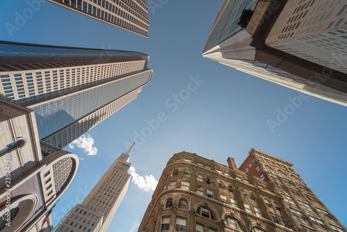 Upward view of skyscrapers against blue sky in the business district area of downtown Dallas, Texas, USA.