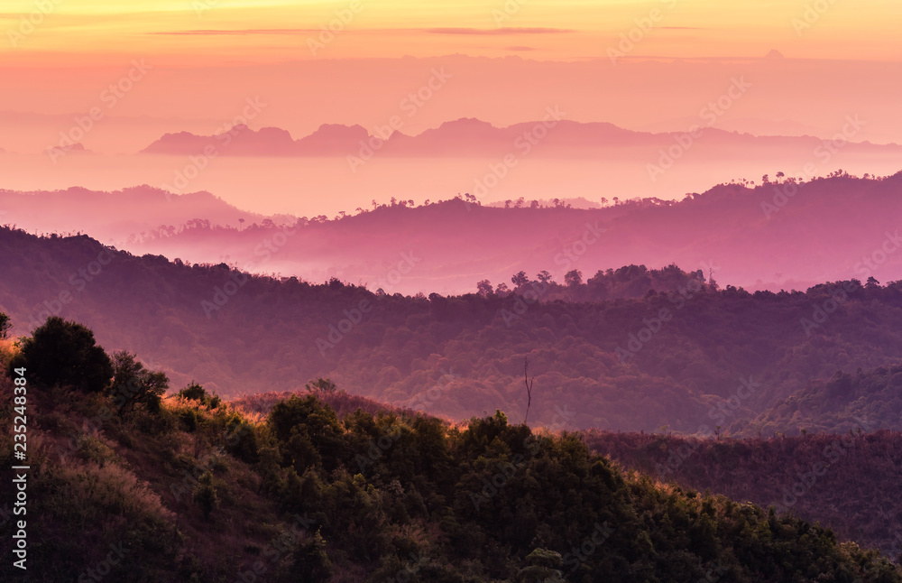 Fototapeta premium Colorful landscape view in early morning before the sunrise with misty covered mountain hills at Thong Pha Phum. Kanchanaburi, Thailand