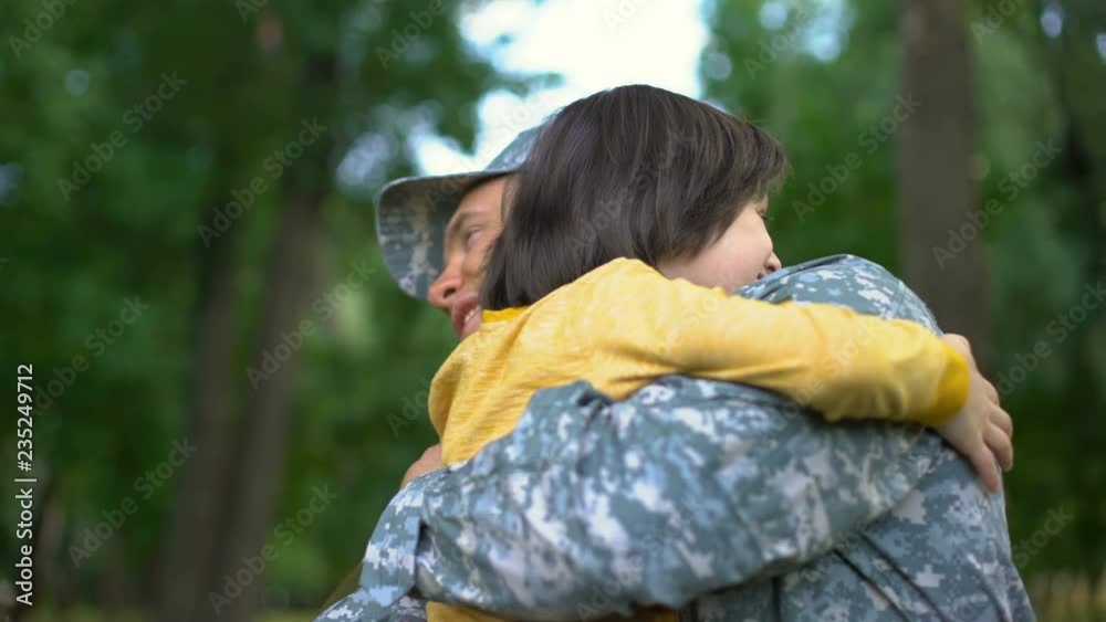 American sergeant giving high five and hugging son, soldier homecoming, family American sergeant giving high five and hugging son, soldier homecoming, family