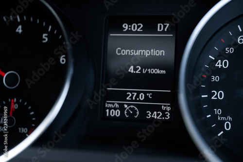 A Modern Car odometer Cluster with LCD Multifunction Display. Meter at constant speed show the fuel consumption efficiency 