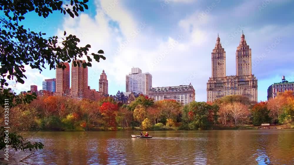 New York City Central Park in Autumn with skyscrapers apartment boat and lake