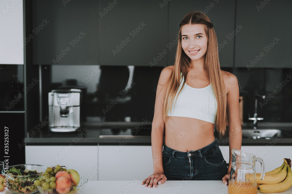 Athletic Girl Stands In Kitchen. Posing Concept. Athletic Girl Stands In Kitchen. Posing Concept.