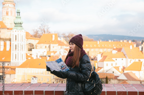 A tourist looks at a map while traveling to Cesky Krumlov in the Czech Republic in the winter.