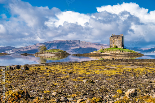 View of the Castle Stalker in autumn on the low tide near Port Appin, Argyll - Scotland photo