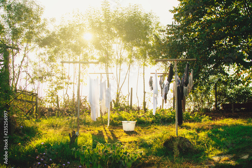 Freshly washed laundry drying on the string outside in the backyard of the farm
