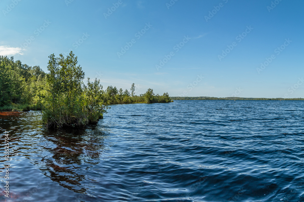 A picturesque lake with water of a reddish hue A picturesque lake with water of a reddish hue