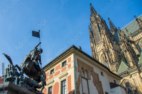 Tower of St. Vitus's cathedral, 14th century statue of st George in the foreground, Prague, Czech Republic