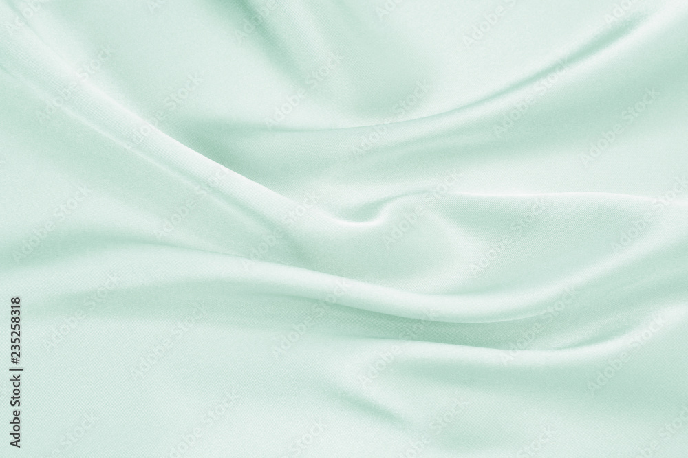 Obraz premium The texture of the satin fabric of green color for the background