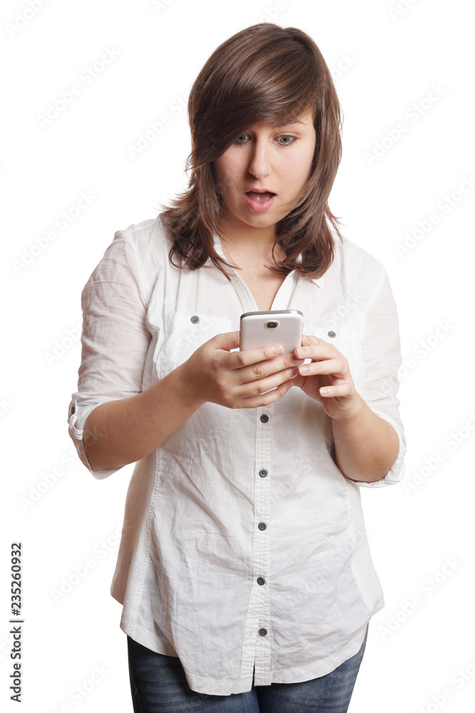 shocked young woman staring at smartphone open-mouthed shocked young woman staring at smartphone open-mouthed