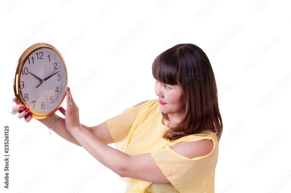 Brunette girl in yellow dress looking at large watch Brunette girl in yellow dress looking at large watch