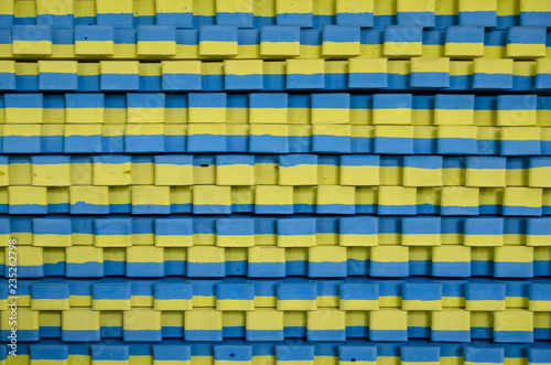 blue-yellow sports mats stacked in large stack