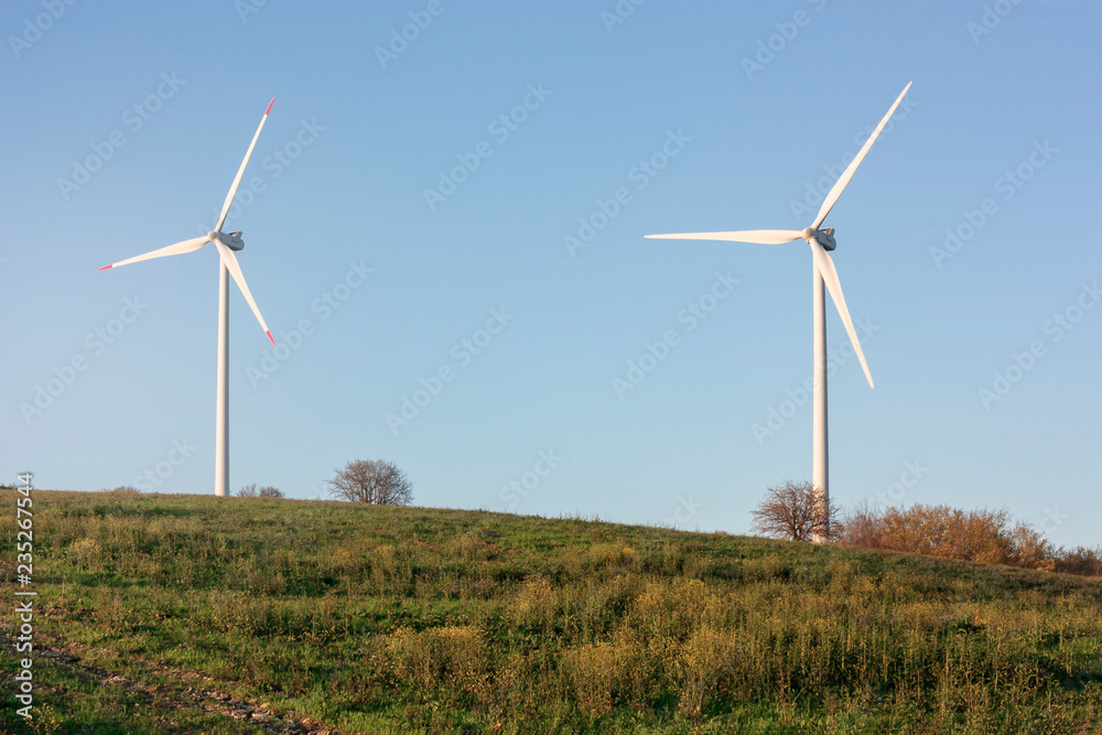 Wind turbines generating electricity - energy conservation concept Wind turbines generating electricity - energy conservation concept
