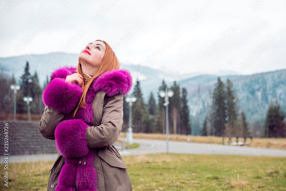 Beautiful woman in fashionable colorful park jaket at cold time outdoor , Fashion for lady, fur coat, autumn - winter season with good mood and luxury clothes, bright make up Beautiful woman in fashionable colorful park jaket at cold time outdoor , Fashion for lady, fur coat, autumn - winter season with good mood and luxury clothes, bright make up