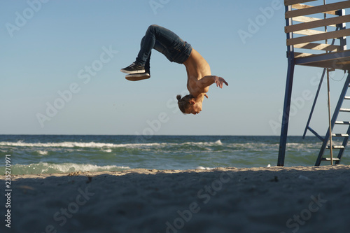 Freedom and creativity, man flipping on the beach