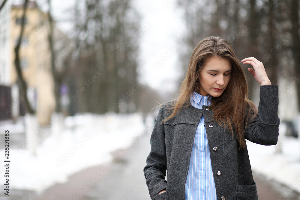 Young adult girl in coat on the street Young adult girl in coat on the street