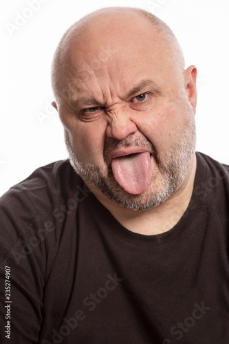 Bald man with tongue hanging out, close-up