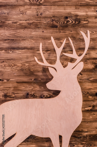 Suluet deer with plywood on the background texture of wood. photo